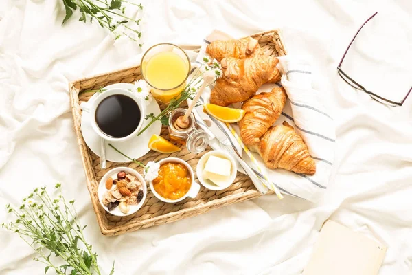 Continental breakfast on white bed sheets - flat lay — Stock Photo, Image