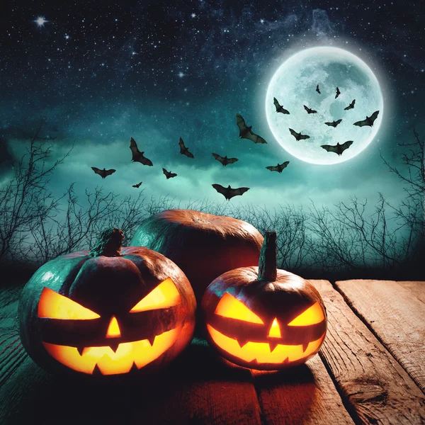 Halloween Pumpkin. Glowing Jack in a dark mist Forest. Elements of this image furnished by NASA