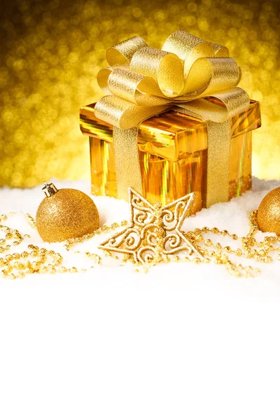 Caja de regalo de oro de Navidad con bolas y estrella en la nieve — Foto de Stock