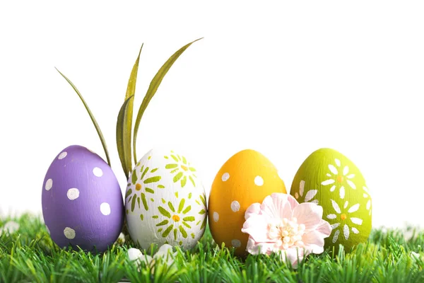 Row of Easter eggs on grass — Stock Photo, Image