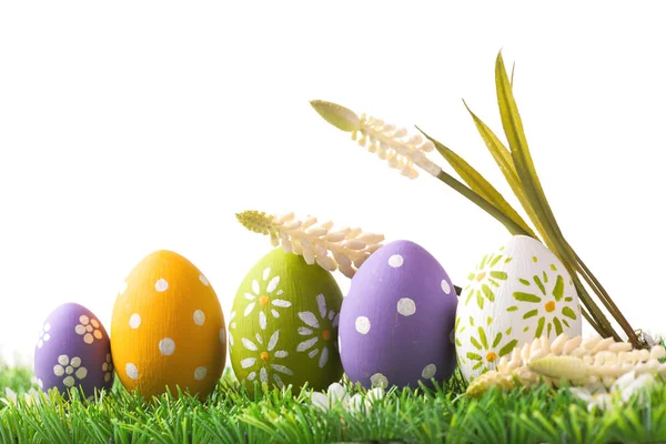 Bunch of easter eggs in pastel colors on grass — Stock Photo, Image