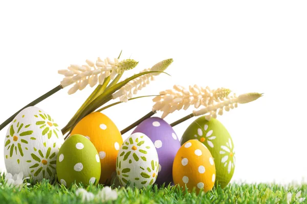 Row of Easter eggs on grass — Stock Photo, Image