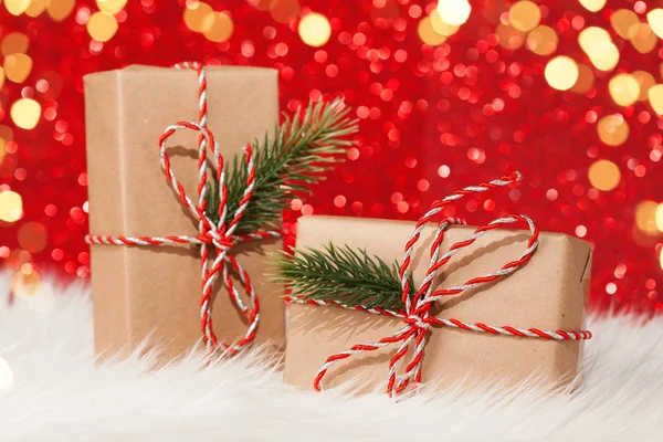 Two gift boxes wrapped with ribbon on red background — Stock Photo, Image