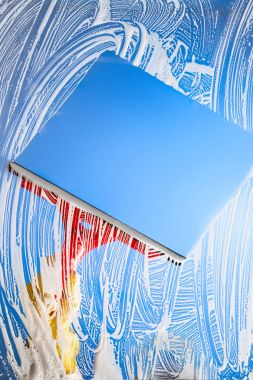 cleaning window with squeegee blue sky clipart