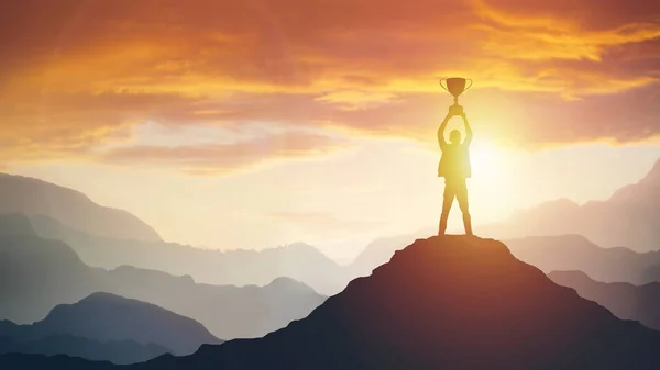 Silhouette of a man holding a trophy at sunset — Stock Photo, Image