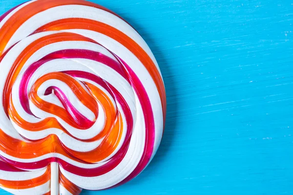 Lollipop candy on a turquoise background — Stock Photo, Image