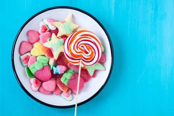 Lollipop and assorted jelly candies — Stock Photo, Image