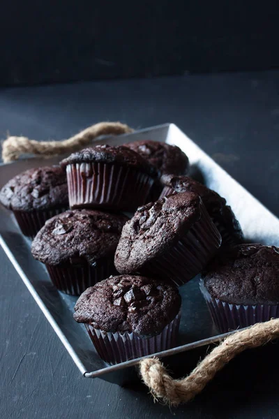 Chocolate muffins on a black background — Stock Photo, Image