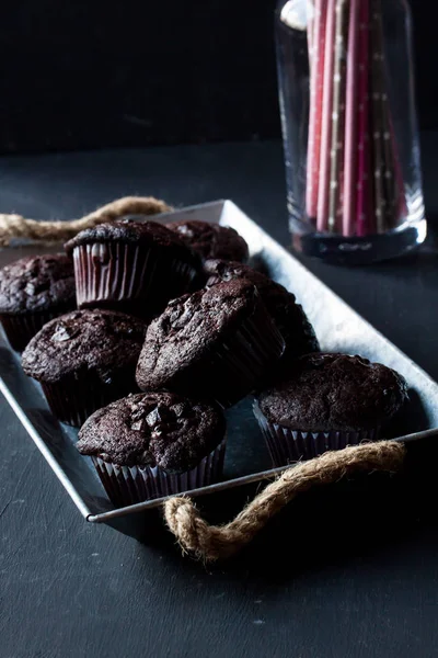 Chocolate muffins on a black background — Stock Photo, Image