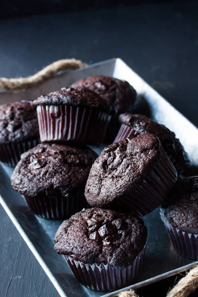 Chocolate muffins on a black background — Stock Photo, Image