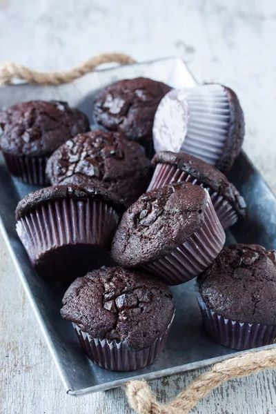 Chocolate muffins on a white wooden background — Stock Photo, Image
