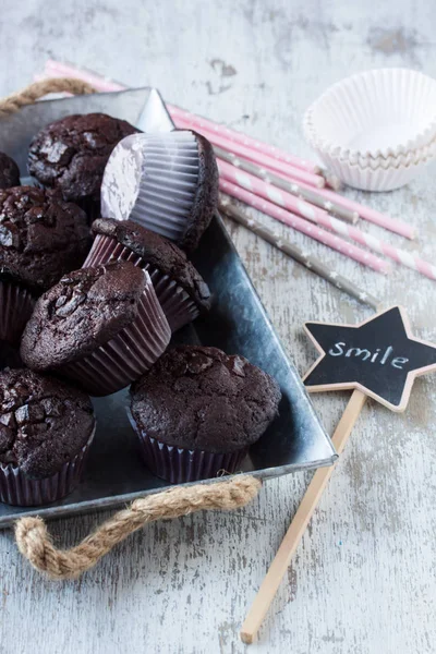 Chocolate muffins on a white wooden background — Stock Photo, Image