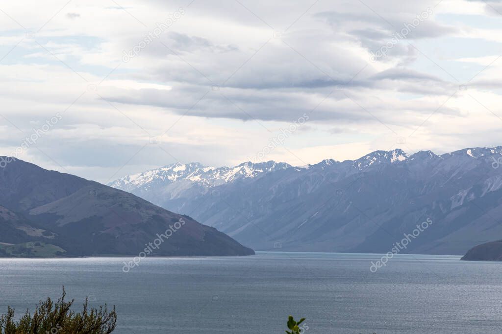 Snow-capped mountains along the shores of Hawea Lake. South Island, New Zealand
