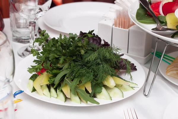 Sliced vegetables with herbs on a platter — Stock Photo, Image