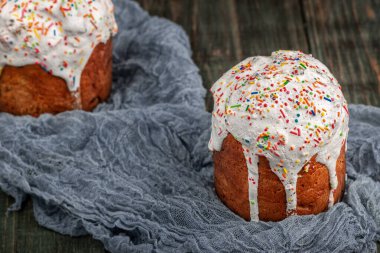 Freshly baked Easter cakes stand on a black wooden table