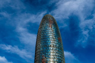The Torre Glories (Glories Tower) stands out against the sky in Barcelona, Spain.