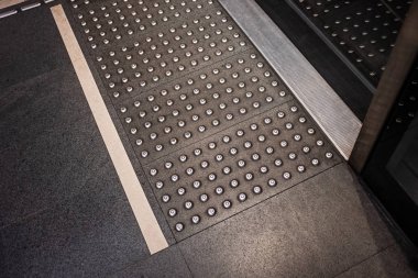 High angle view tactile ground surface indicators at the access point for subway train in Brescia (Italy).