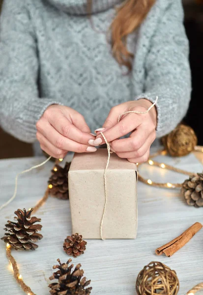 Woman packs a gift for the New Year holidays