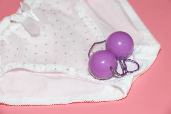 Double pink vaginal balls lie on the panties. — Stock Photo, Image