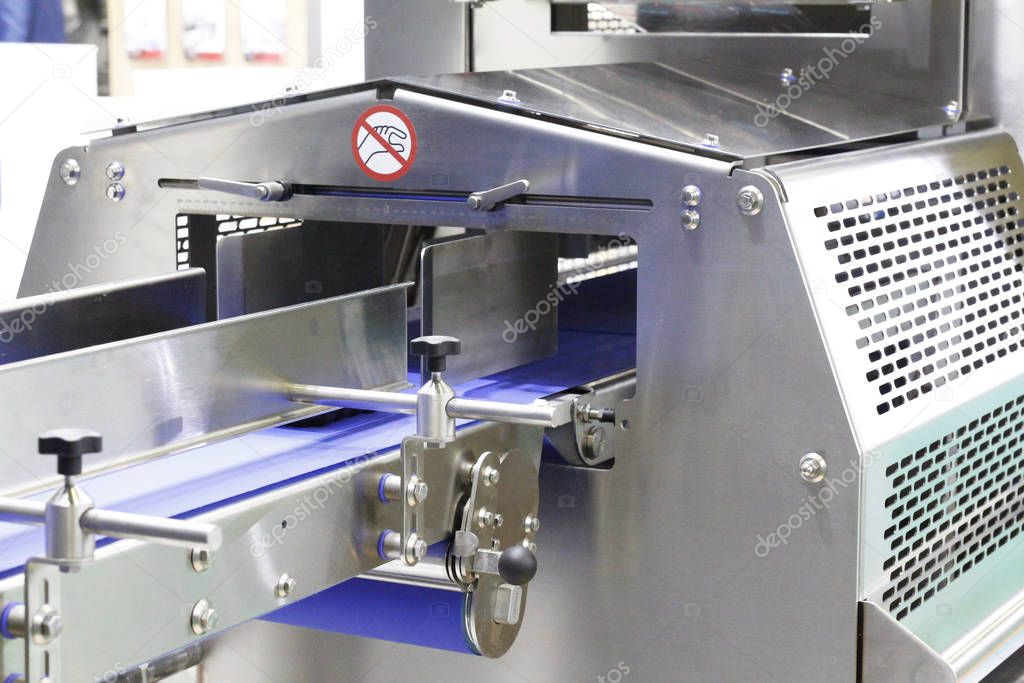 Automatic machine in a food factory. Filling equipment.