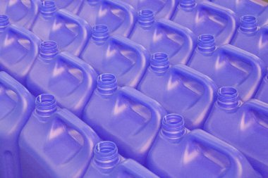 A lot of bottles without lids made of purple plastic. clipart