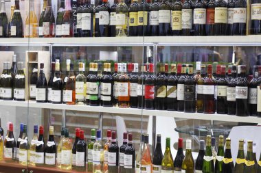 Many different bottles of wine and champagne.