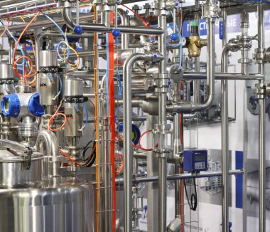 Moscow, RF, 02.20.2020: Installation of centrifugal separation and pasteurization. Globe valves in a dairy factory. Stainless steel pumps.