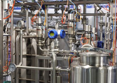 Moscow, RF, 02.20.2020: Installation of centrifugal separation and pasteurization. Globe valves in a dairy factory. Stainless steel pumps.