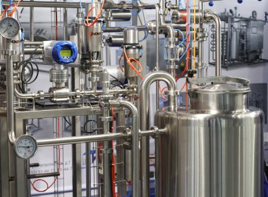 Moscow, RF, 02.20.2020: Installation of centrifugal separation and pasteurization. Globe valves in a dairy factory. Stainless steel pumps.