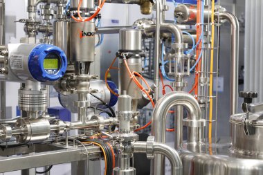 Moscow, RF, 02.20.2020: Installation of centrifugal separation and pasteurization. Globe valves in a dairy factory. Stainless steel pumps.