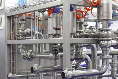 Moscow, RF, 02.20.2020: Installation of centrifugal separation and pasteurization. Globe valves in a dairy factory. Stainless steel pumps.