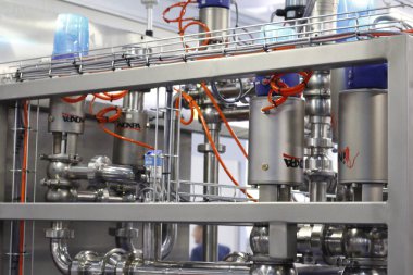 Moscow, RF, 02.20.2020: Installation of centrifugal separation and pasteurization. Globe valves in a dairy factory. Stainless steel pumps.