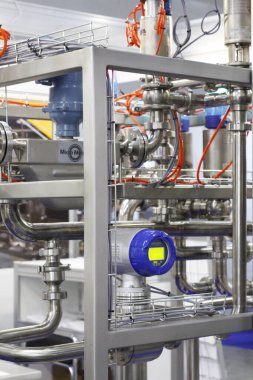 Moscow, RF, 02.20.2020: Installation of centrifugal separation and pasteurization. Globe valves in a dairy factory. Stainless steel pumps.