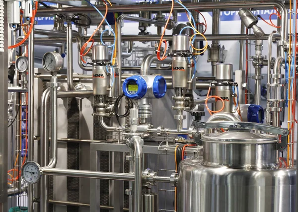 Moscow, RF, 02.20.2020: Installation of centrifugal separation and pasteurization. Globe valves in a dairy factory. Stainless steel pumps.