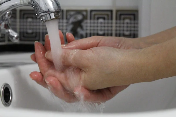 Hand washing. Wash hands under running water.