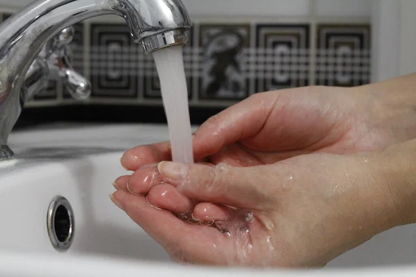 Hand washing. Wash hands under running water.