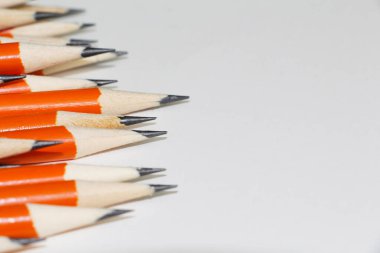 Beyaz arka planda bir sürü siyah kurşun kalem var. Kurşun kalemler. Bir sürü sivri uçlu kalem..