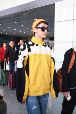 Chinese actor and singer-songwriter Xu Weizhou or Timmy Xu arrives at a Beijing airport after landing in Beijing, China, 29 February 2020. clipart