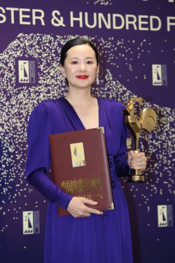 Chinese actress Yong Mei wins the Golden Rooster Awards for Best Actress for her performance in So Long, My Son, which helped her to win Silver Bear for Best Actress earlier this year, in Xiamen city, east China's Fujian province, 23 November 2019 clipart
