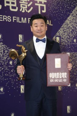 Chinese actor Wang JIngchun wins the Golden Rooster Awards for Best Actor for his performance in So Long, My Son, which helped him to win the Silver Bear for Best Actor earlier this year, in Xiamen city, east China's Fujian province, 23 November 2019 clipart