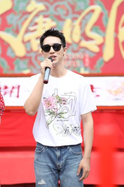 Chinese actor and singer-songwriter Xu Weizhou, also known as Timmy Xu, shows up with glasses and pink T-shirt at the opening ceremony of his new TV series at Hengdian World Studios, Dongyang county-level city, Jinhua city, east China's Zhejiang prov clipart