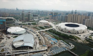 An aerial of natatorium and stadium, whose main structure finish and turn to indoor decoration and construction, and which will be respectively used as the court for basketball games and swimming and diving games of 2022 Asian Games, Hangzhou city, clipart