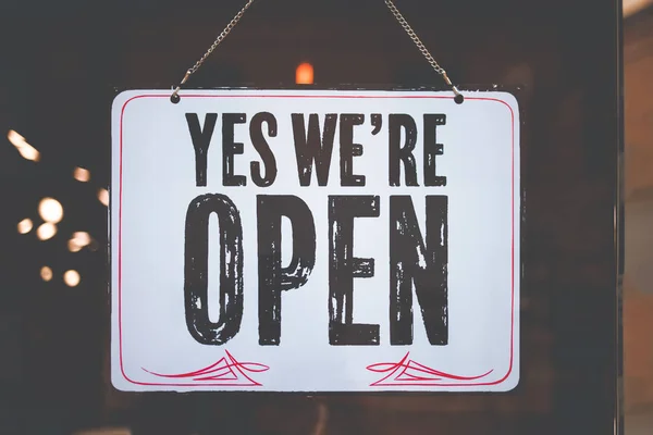 the inscription we are open on the glass windows of the institution