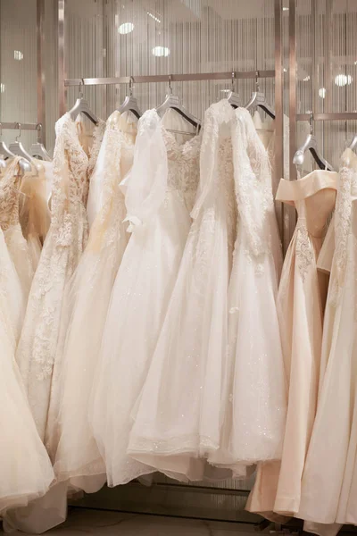 Elegant dresses in the wedding salon. The choice of wedding dresses in the store