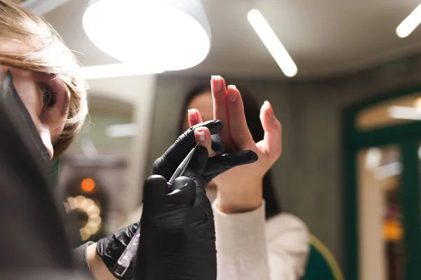 Cuticle care during a manicure process in a nail salon