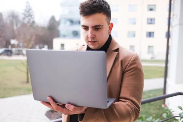 Concentrated young guy looking at a laptop