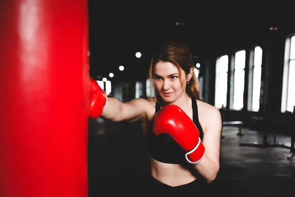 Woman practicing punching on a punching bag