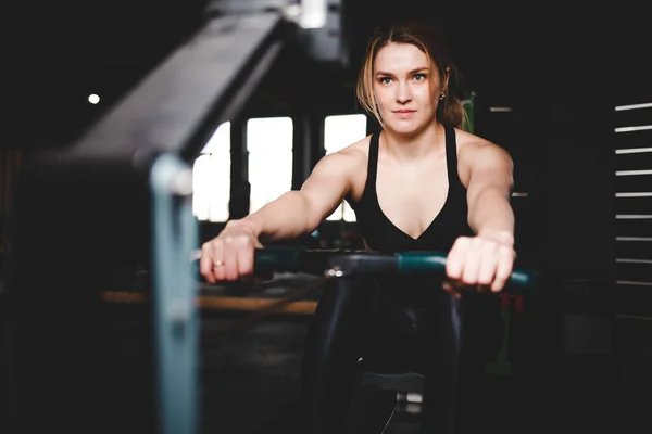 Woman trains on a rowing machine