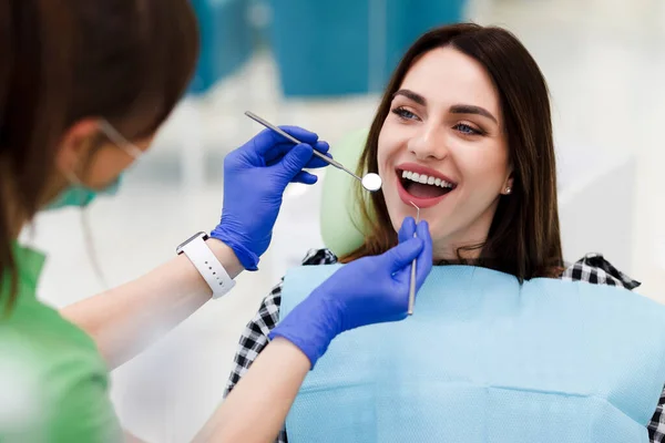 Smiling woman at the dentist\'s appointment. Positive girl visits the dentist and wants to make her teeth even better