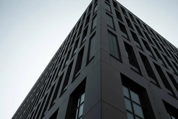 Facade of a dark office building. Perspective of a skyscraper